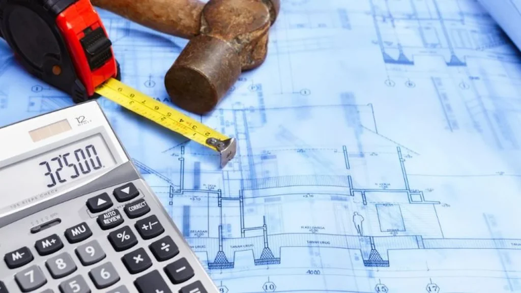 Engineering calculations and blueprint on a desk