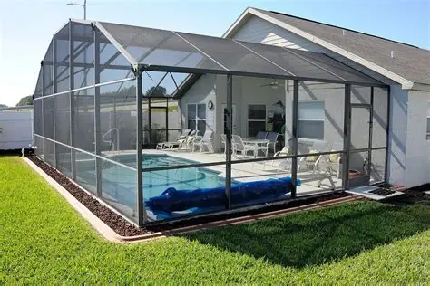 Residential inground pool with deck and screen enclosure